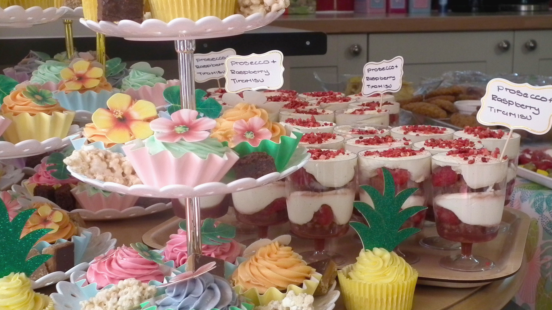 Bright and festive decorated desserts at the care home summer party, including brownies, prosecco raspberry tiramisu and colourful cupcakes decorated with flowers