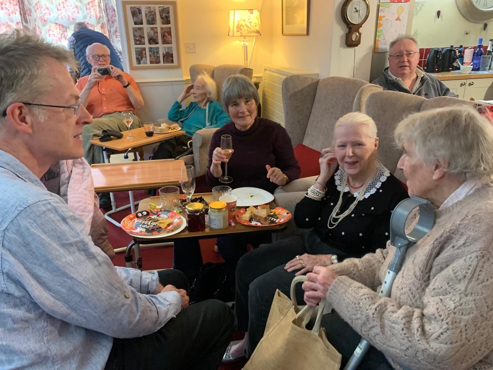 A few residents and relatives enjoying food at the Halloween party.