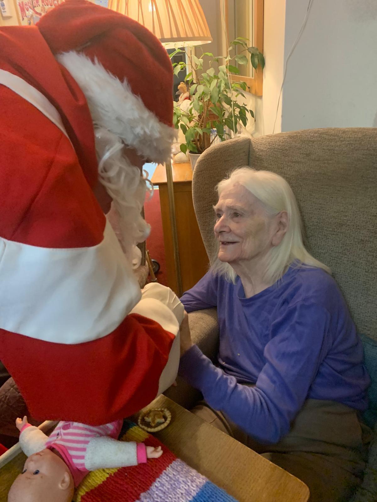 Father Christmas greets a resident