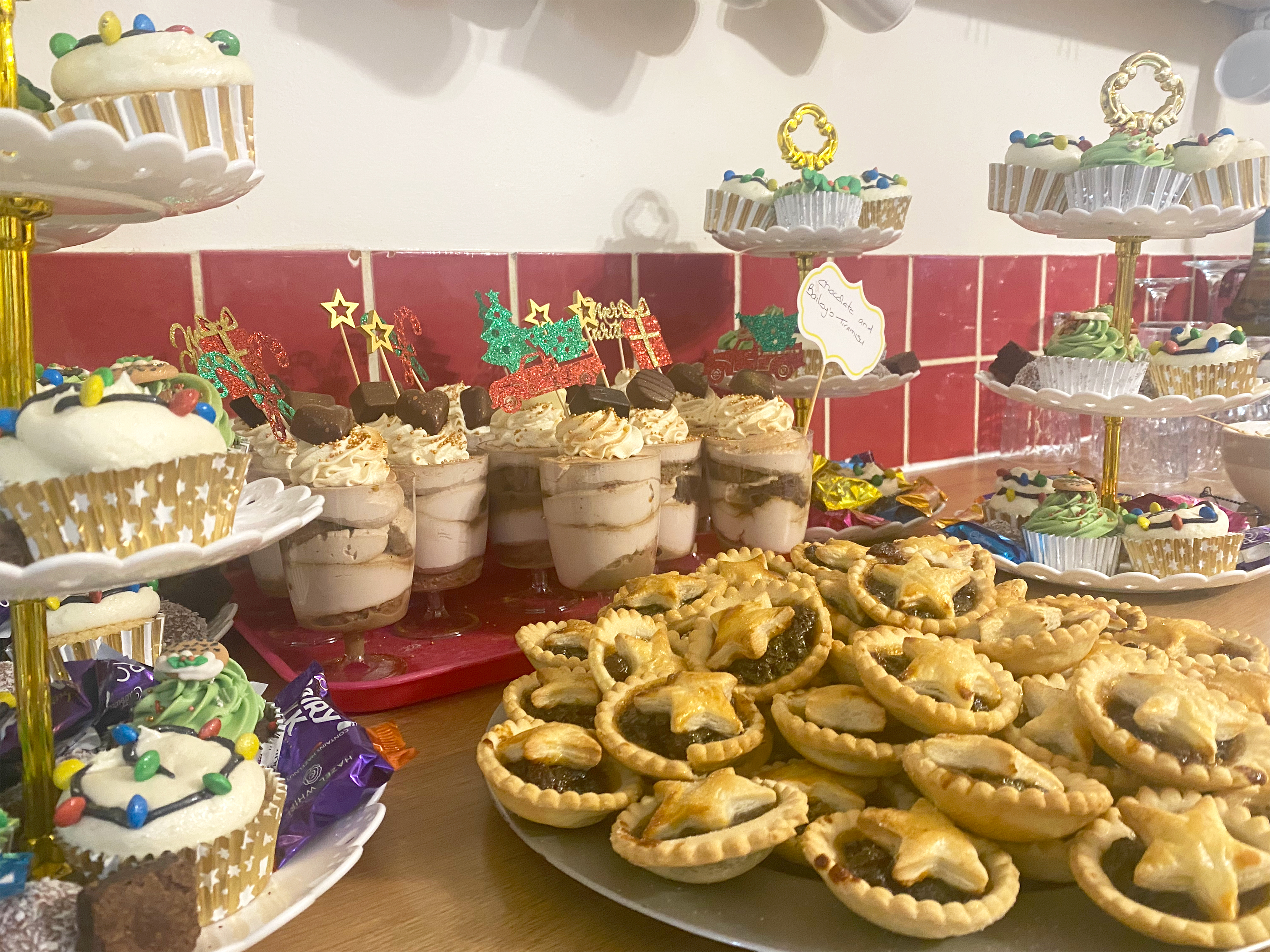Variety of puddings at the Christmas party including mince pies, decorated cupcakes and chocolate and baileys tiramisu