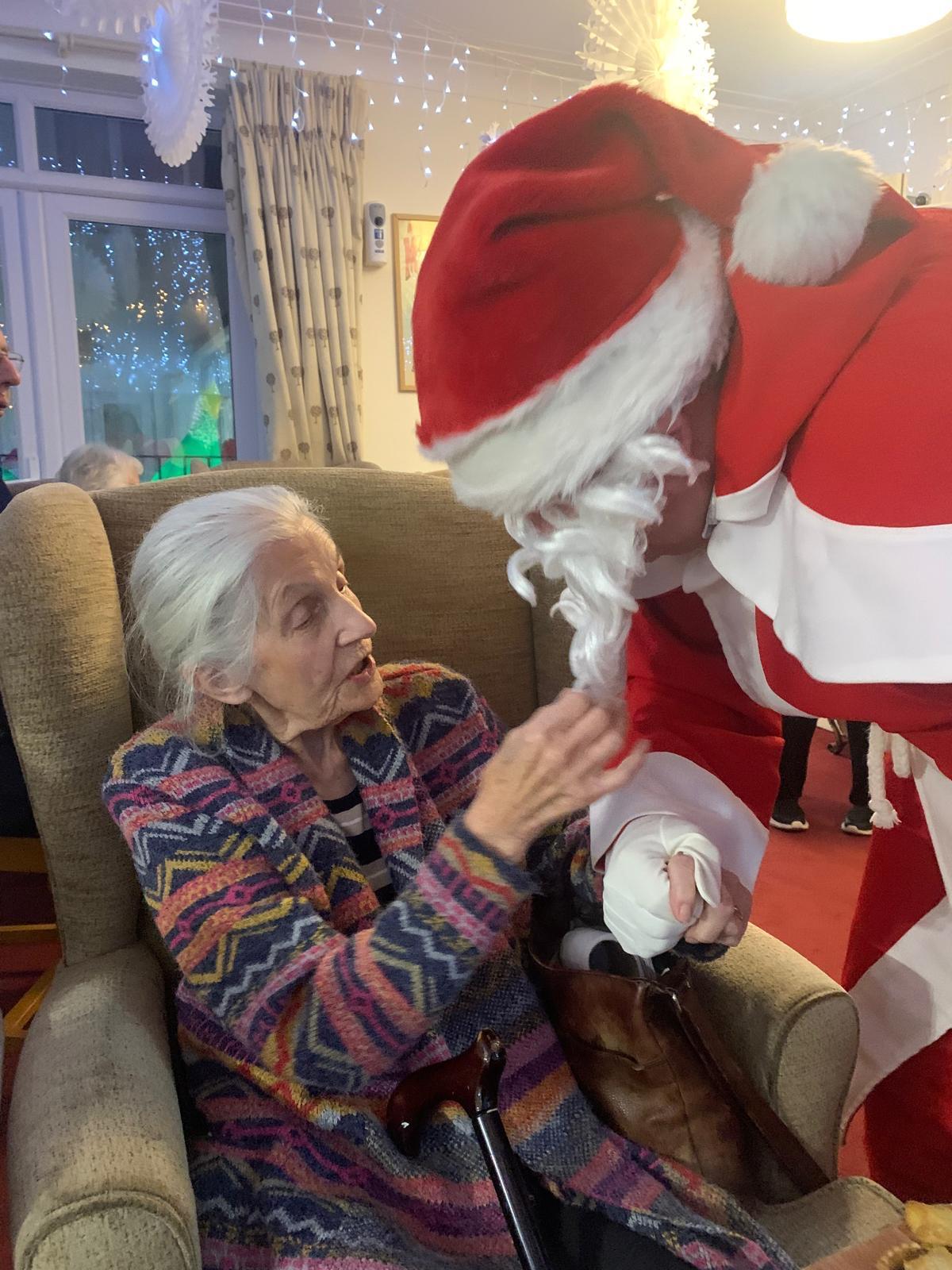 Father Christmas greets a resident at the home