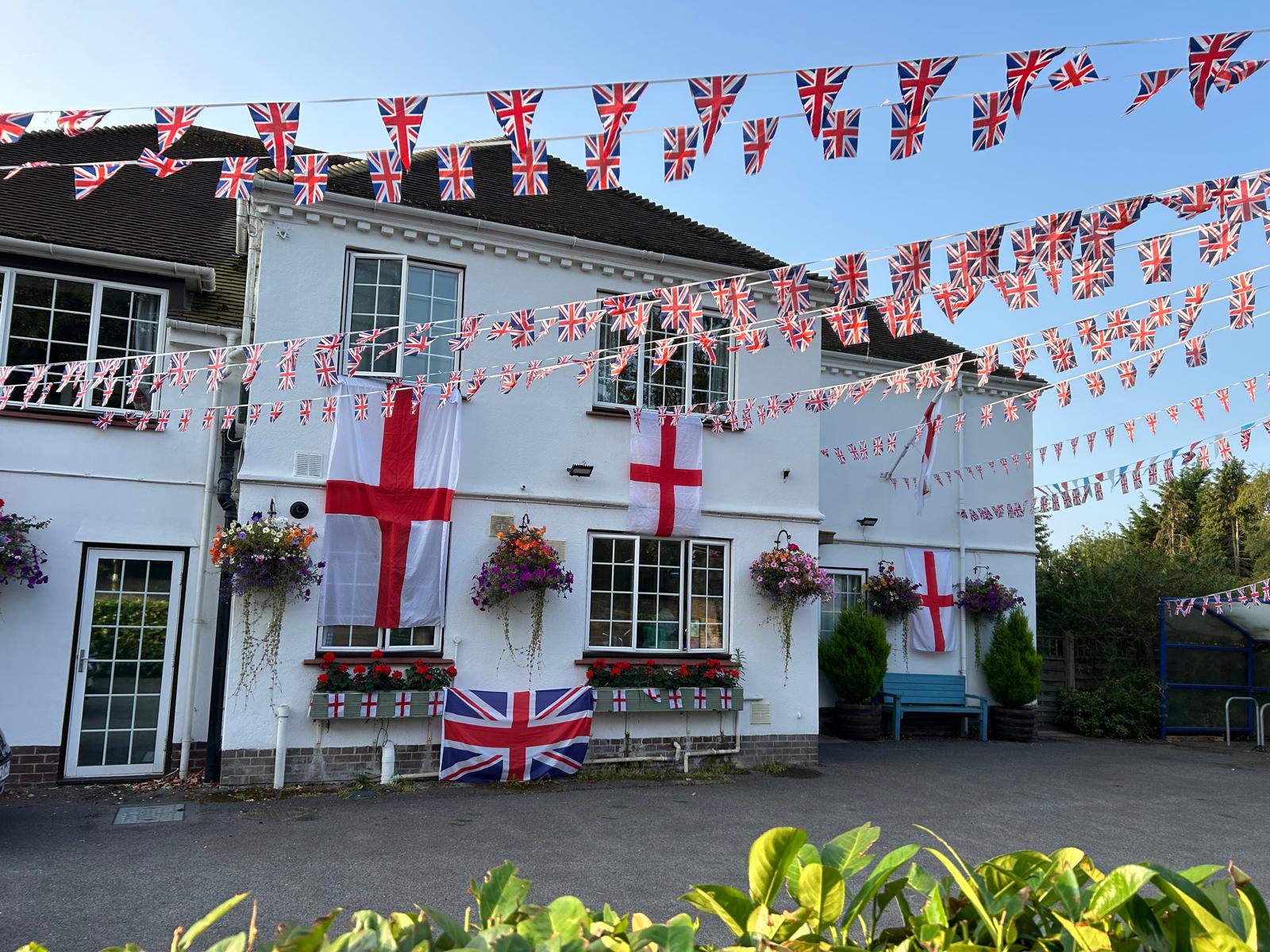 Outside of St Andrew's Care Home is decorated with British and English flags and colourful flowers