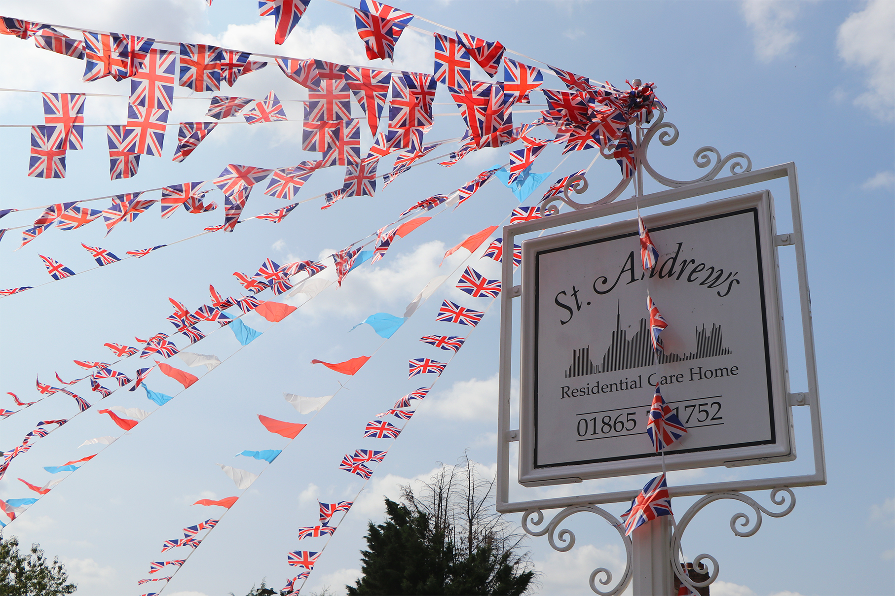 St Andrew's Residential Care Home sign is decorated with strings of British flag bunting